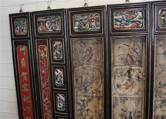 A Chinese 12 panel polychrome and gilt wood screen, 19th century, 274cm x 118cm, hinges removed for hanging